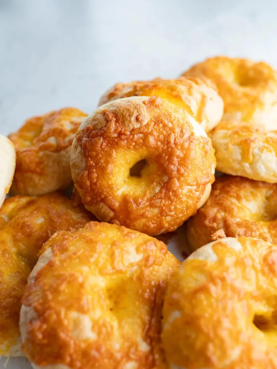Cheddar sourdough bagels topped with browned old cheddar