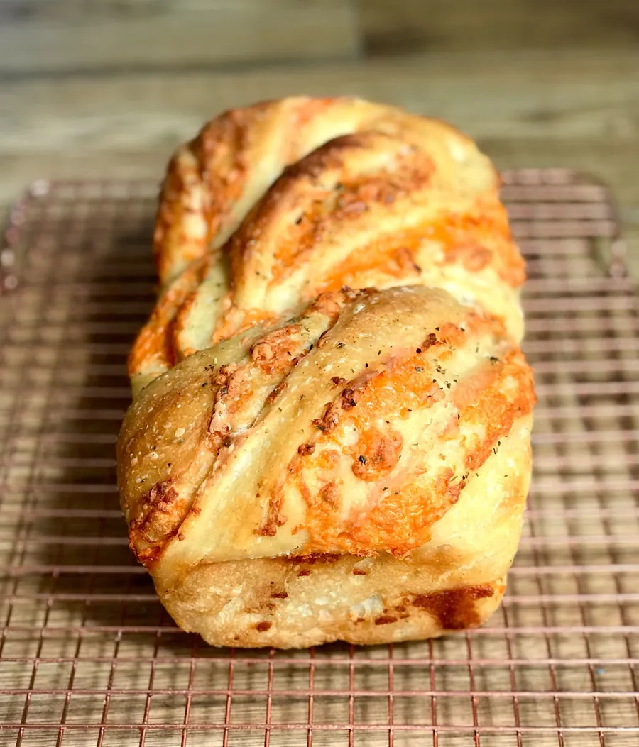 The cheesy garlic loaf, cheddar and garlic swirled through the crumb and topped with Italian herbs